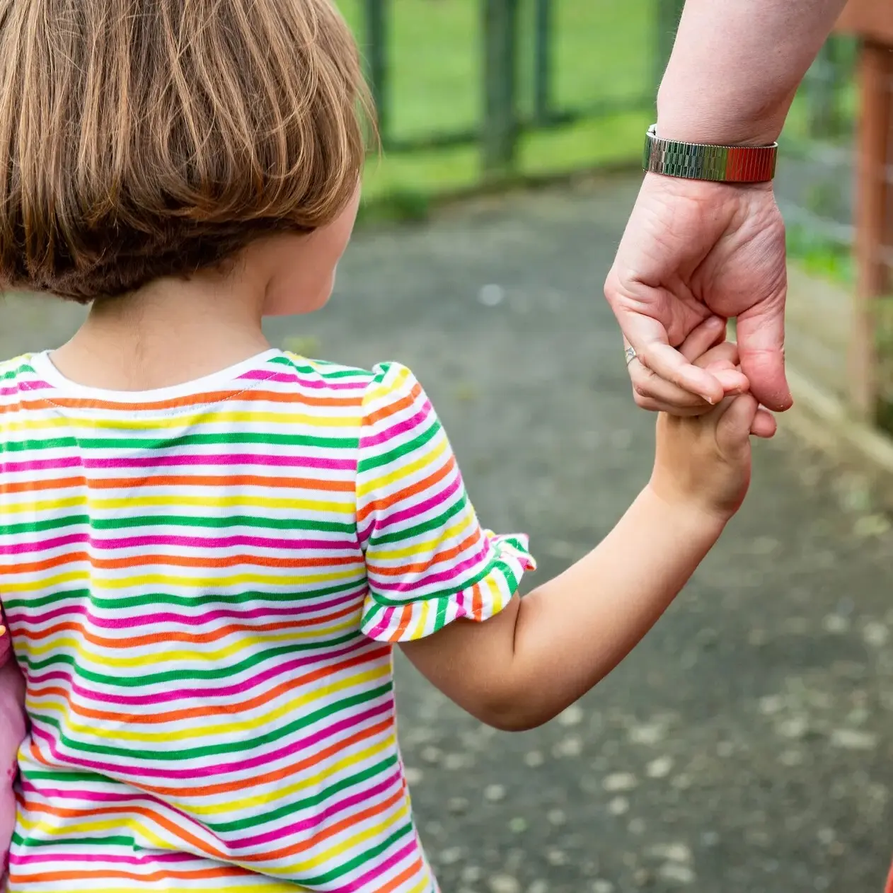 Child-holds-hand-with-volunteer Child-holds-hand-with-volunteer